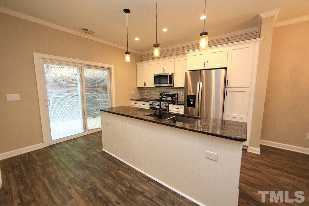 1009 Dual Parks Road Apex, NC 27502 - Photo 5 of 15 Updated kitchen has stainless steel appliances and gorgeous quartz countertops.