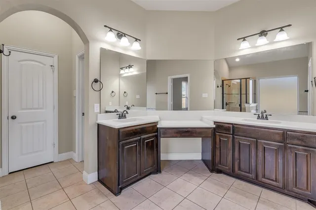 a spacious bathroom with a sink and a mirror