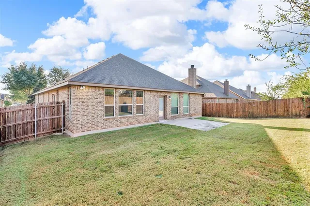 a view of a house with a yard and a garden