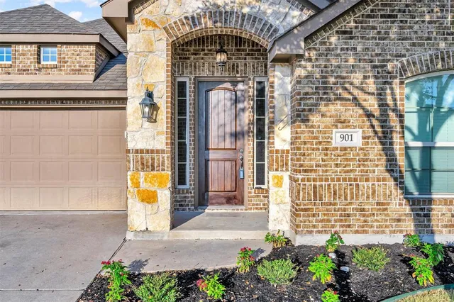 a front view of a house with a garden