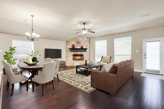 a living room with fireplace furniture and a wooden floor