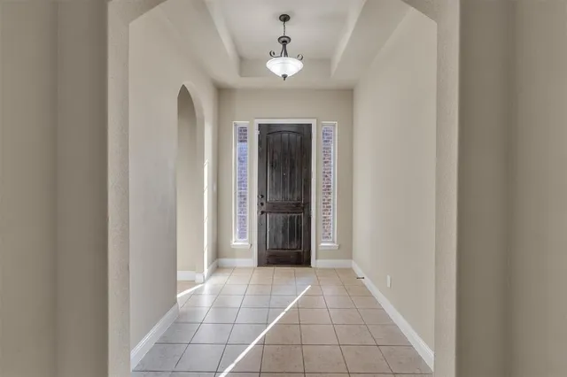 a view of a hallway with a chandelier