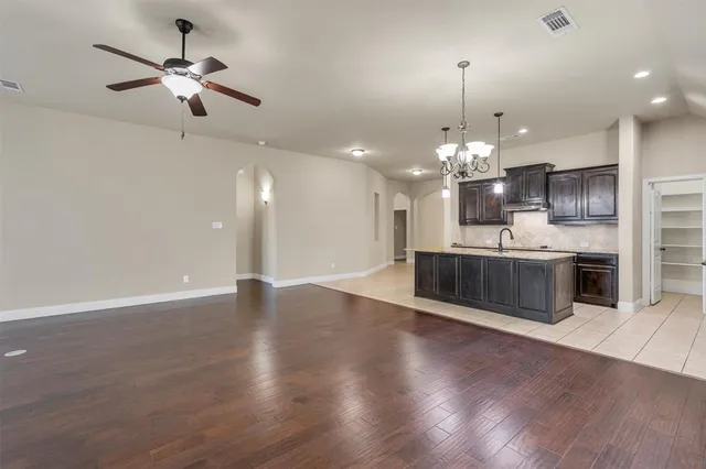 a view of a kitchen with a sink and a chandelier
