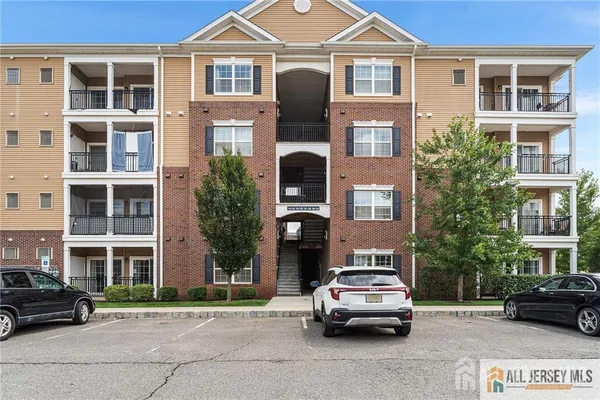 a front view of a residential apartment building with a yard