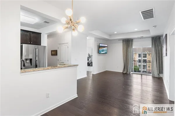 a view of a kitchen with wooden floor and a ceiling fan