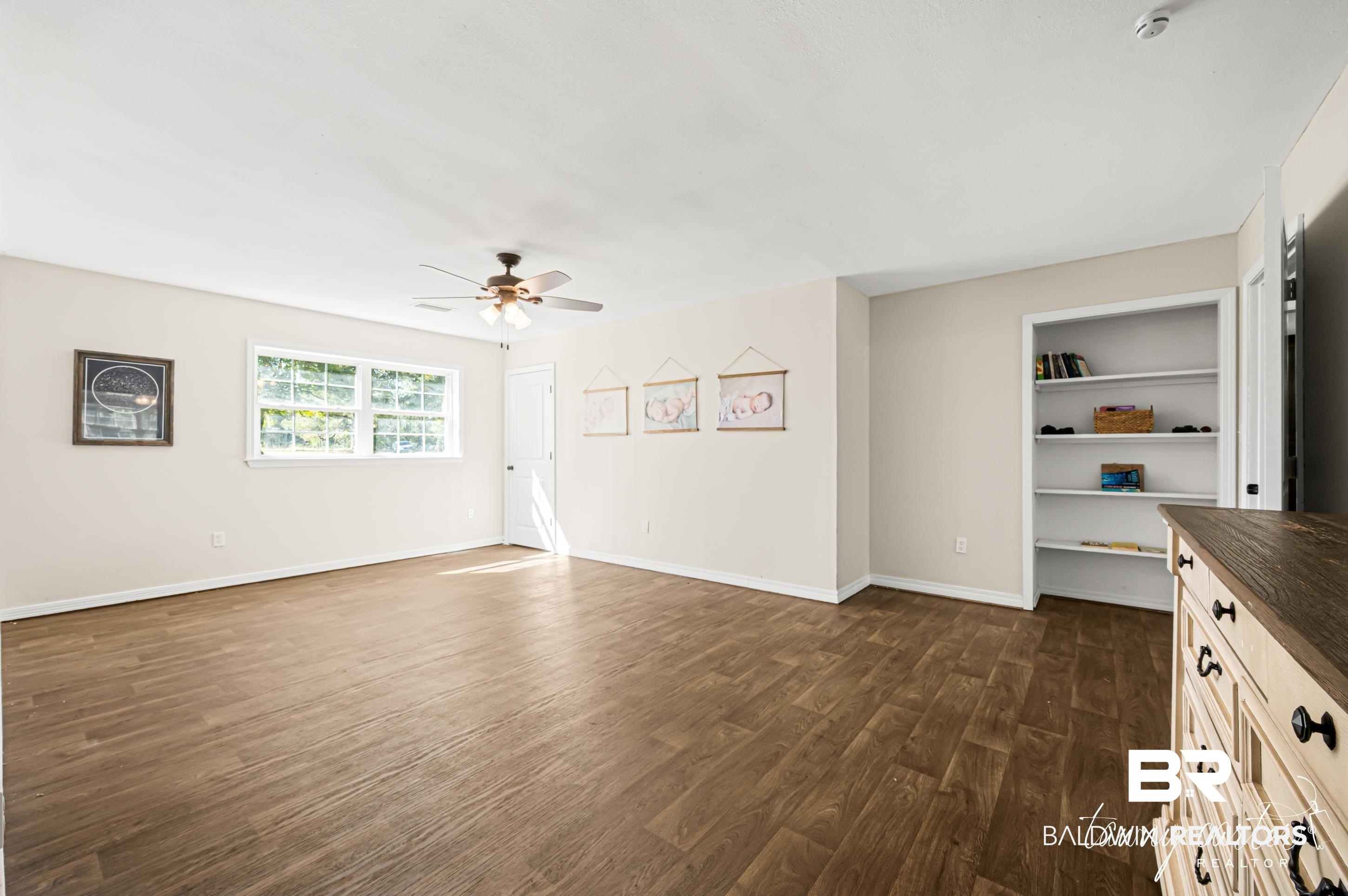 3086 Wild Fork Road Frisco City, AL 36445 - Photo 15 of 30 Unfurnished living room featuring dark wood finished floors and ceiling fan