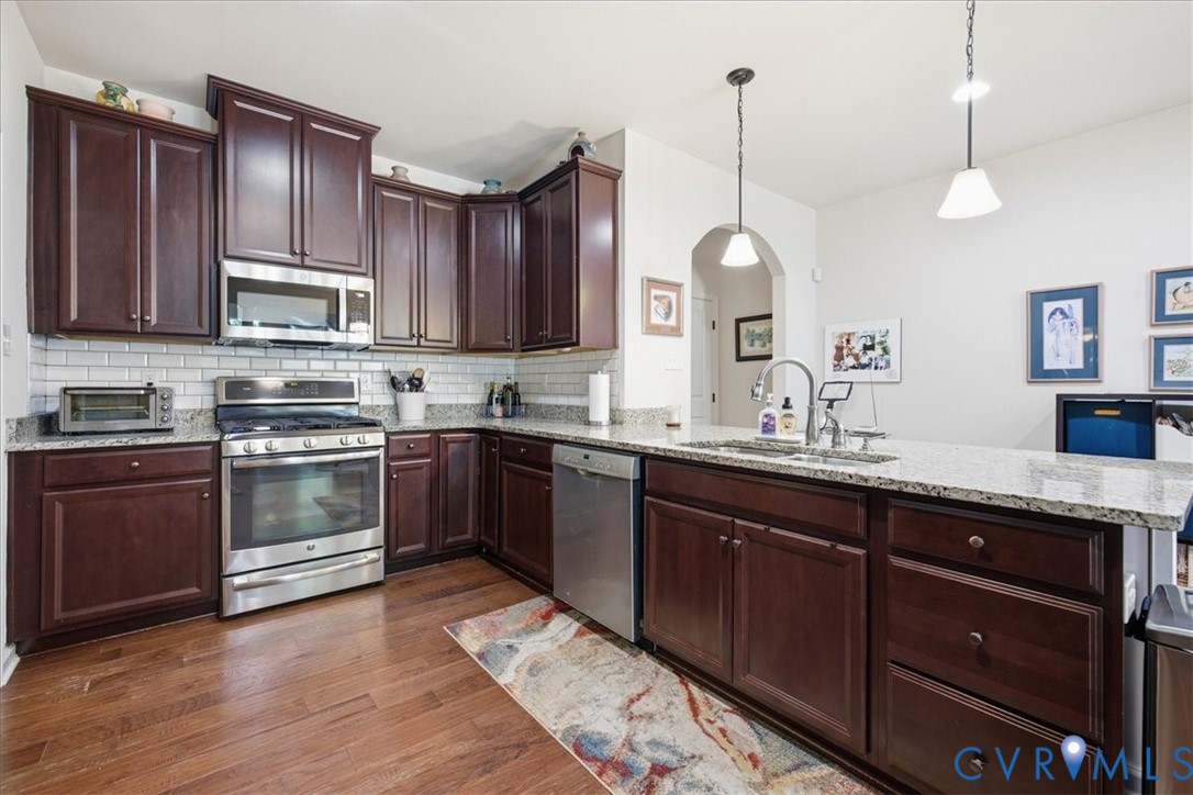 Kitchen featuring wood-finish flooring, dark wood
