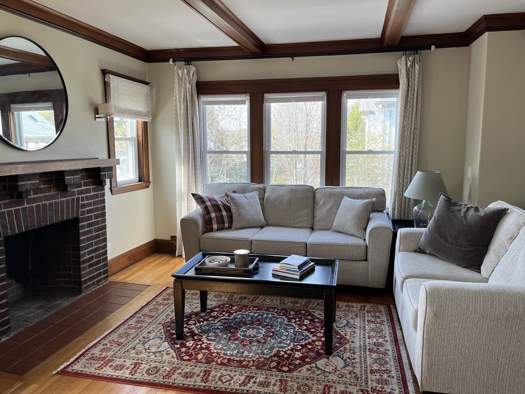 3 Chester Road, Unit 3 Belmont, MA 02478 - Photo 11 of 40 a living room with furniture a rug a fireplace and a large window