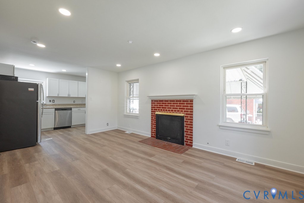3400 Ryburn Road Richmond, VA 23234 - Photo 9 of 45 Living area featuring a brick fireplace with a whi