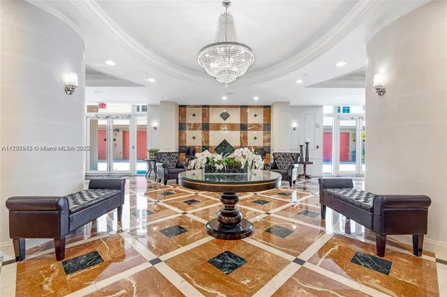 a living room with fireplace furniture and a chandelier