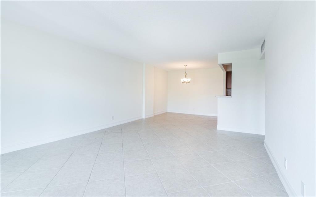 950 Ponce De Leon Road, Unit 408 Boca Raton, FL 33432 - Photo 9 of 51 an empty room with an entryway