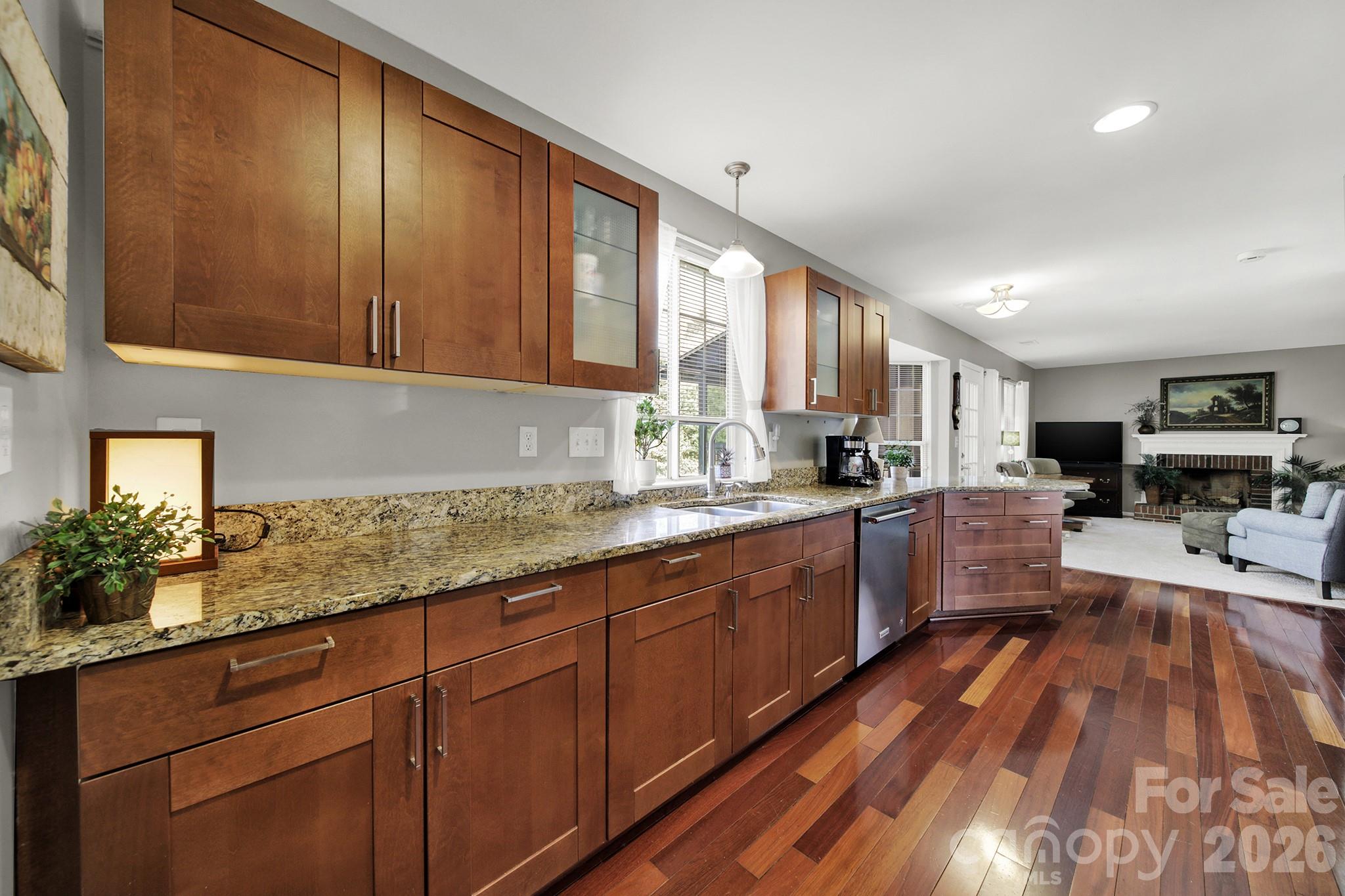 263 Fox Hollow Road Mooresville, NC 28117 - Photo 12 of 44 a kitchen with stainless steel appliances granite countertop wooden cabinets a sink and dishwasher a stove with wooden floor