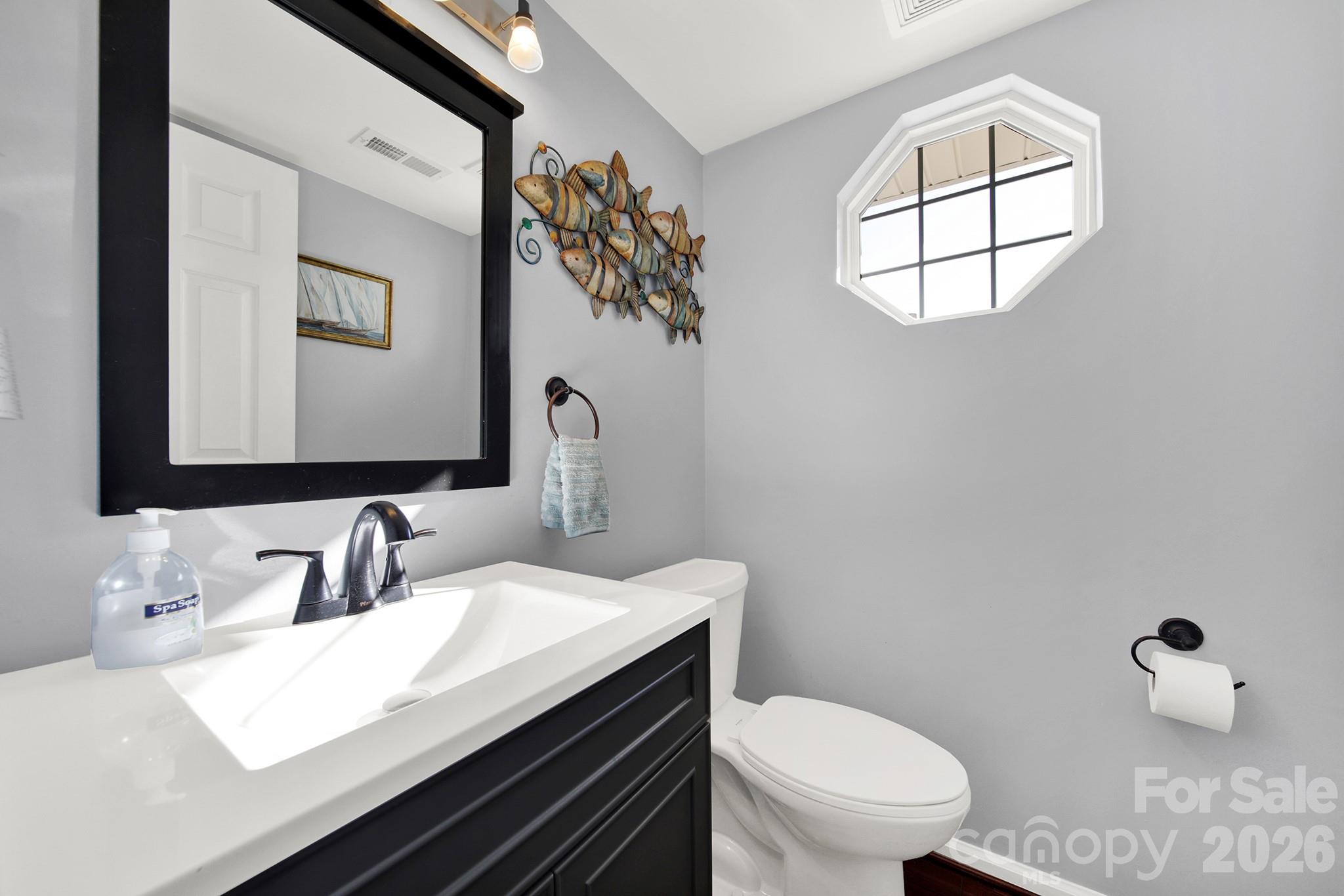 263 Fox Hollow Road Mooresville, NC 28117 - Photo 15 of 44 a bathroom with a toilet sink and mirror