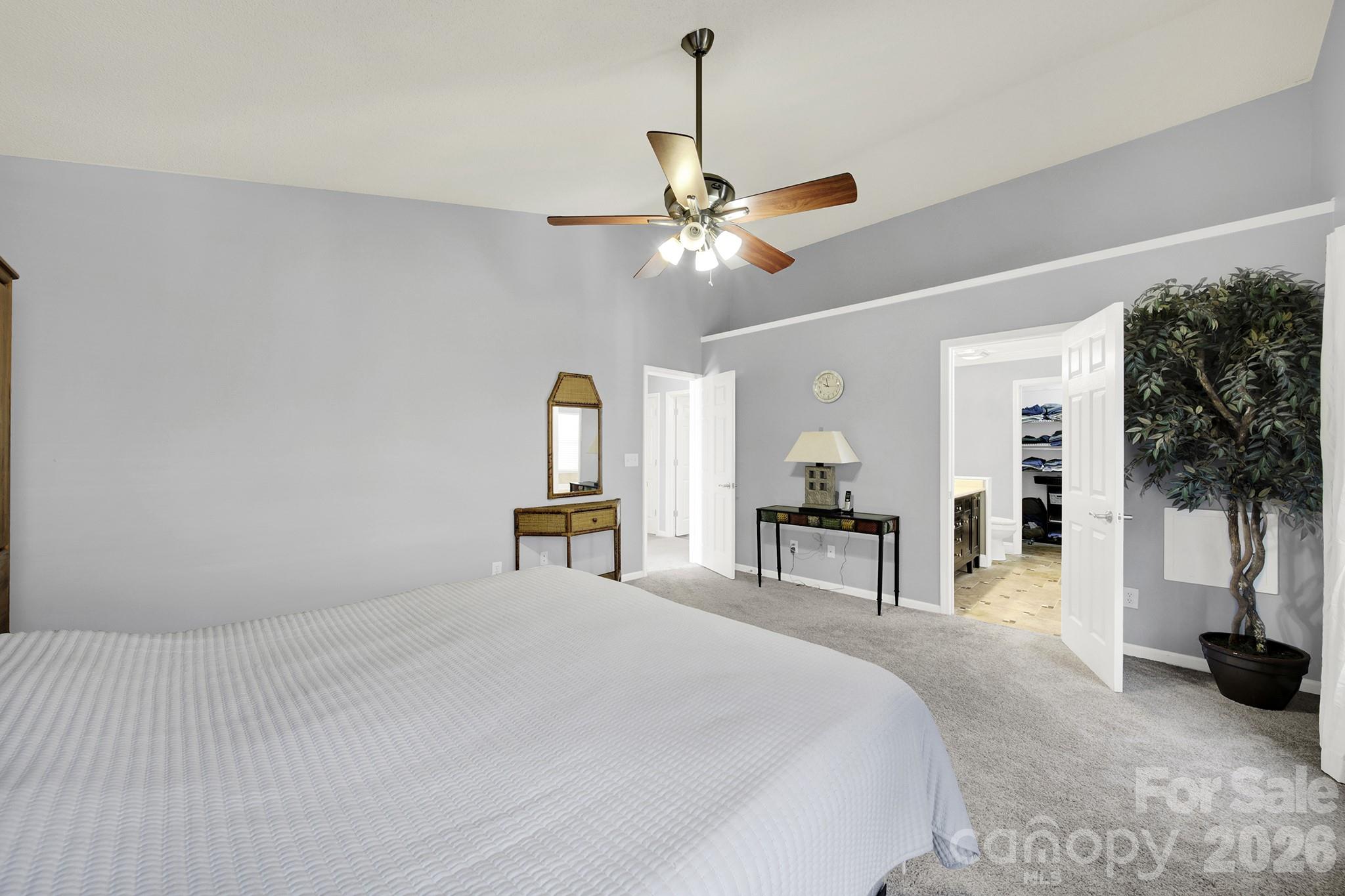 263 Fox Hollow Road Mooresville, NC 28117 - Photo 18 of 44 a bedroom with a bed and a chandelier