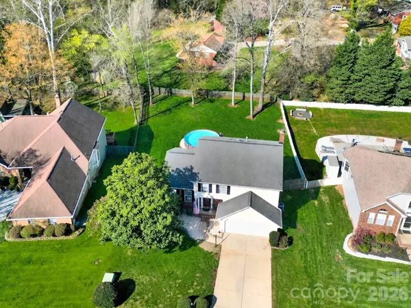an aerial view of a house with garden space and a street