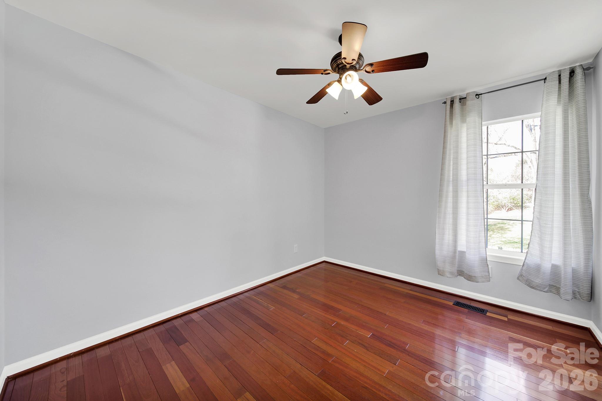 263 Fox Hollow Road Mooresville, NC 28117 - Photo 21 of 44 a view of empty room with wooden floor and fan