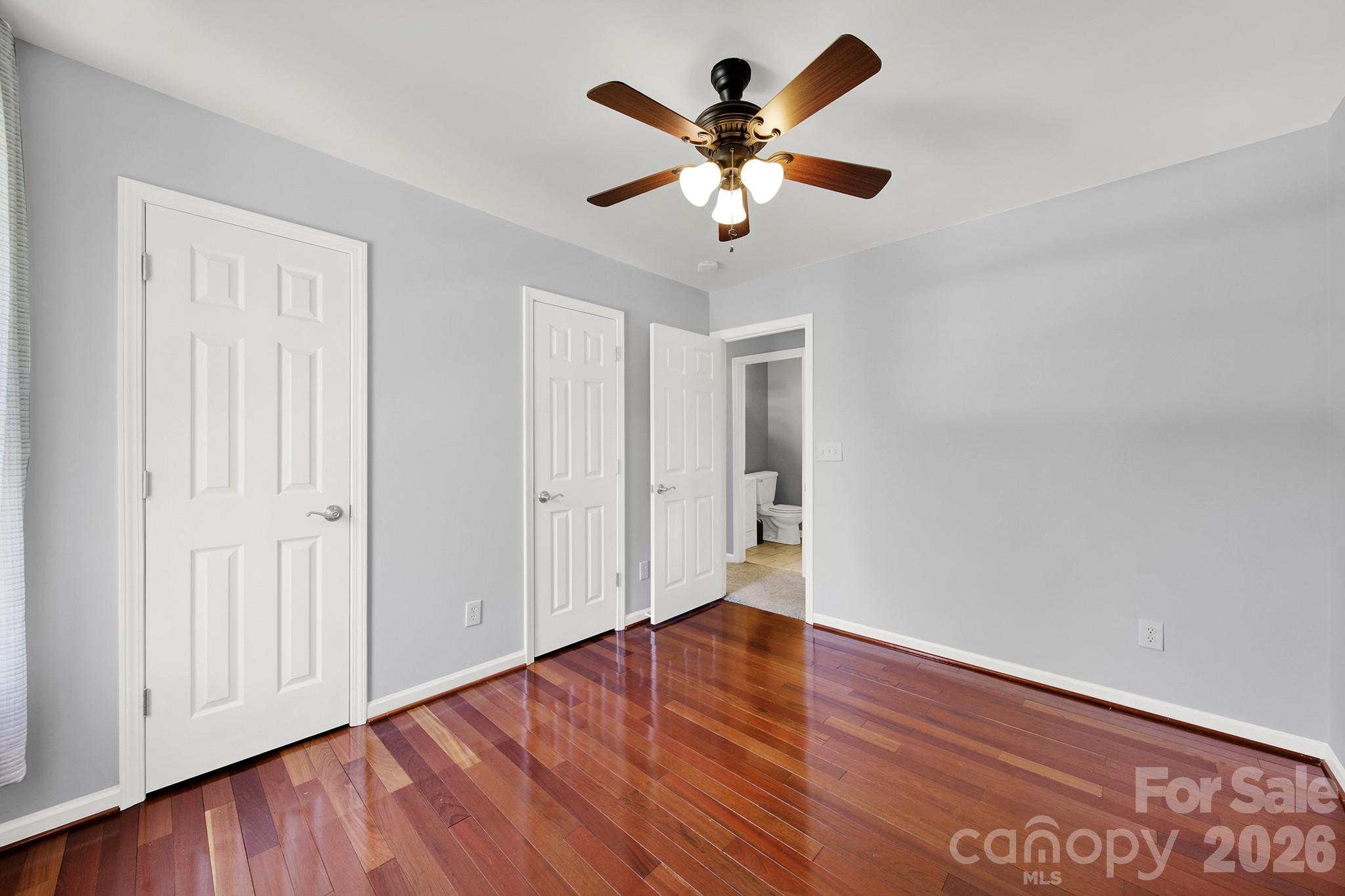 263 Fox Hollow Road Mooresville, NC 28117 - Photo 22 of 44 an empty room with wooden floor and windows