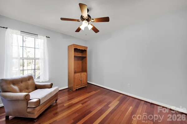 a living room with furniture and a ceiling fan
