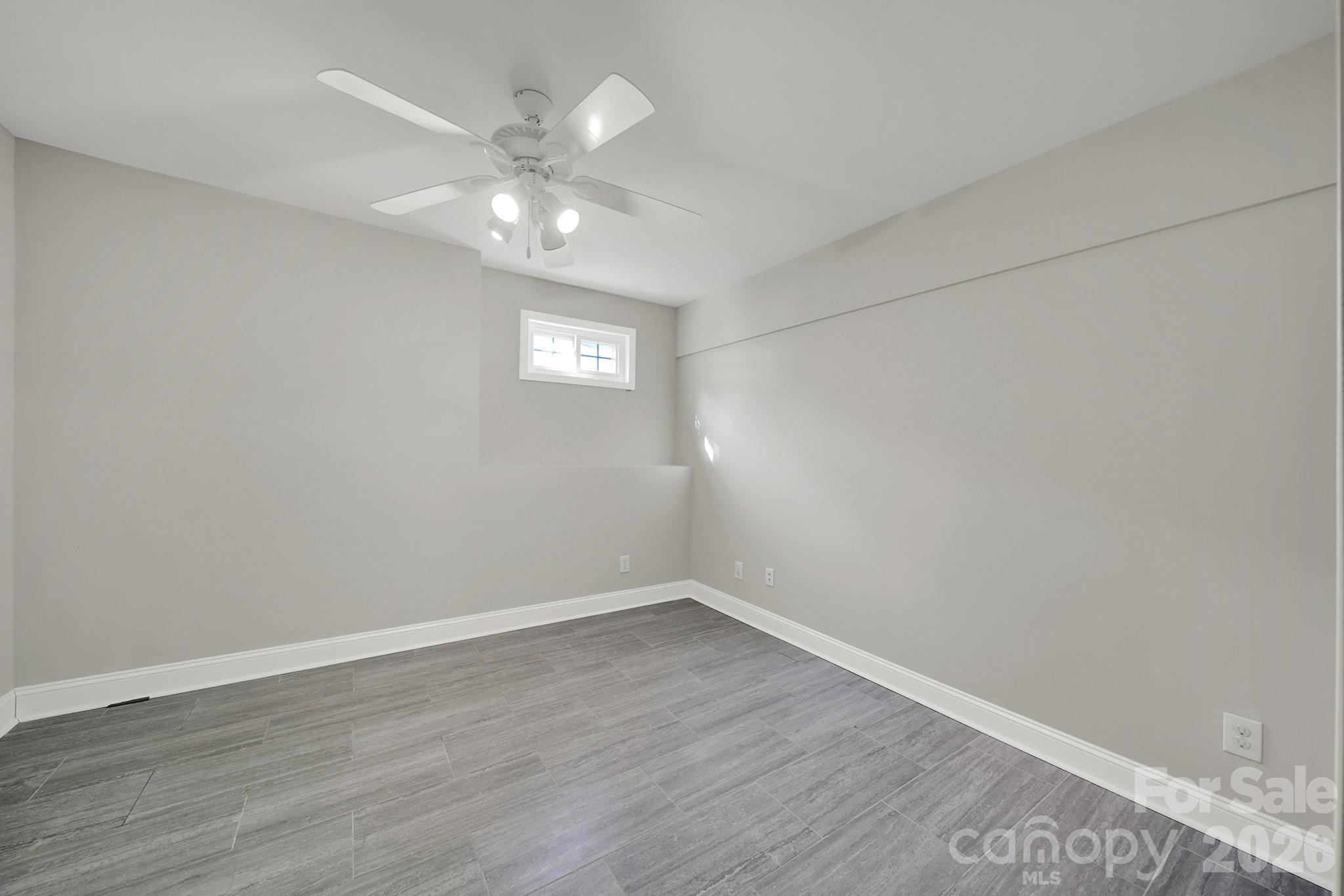 263 Fox Hollow Road Mooresville, NC 28117 - Photo 29 of 44 a view of an empty room with wooden floor and a ceiling fan