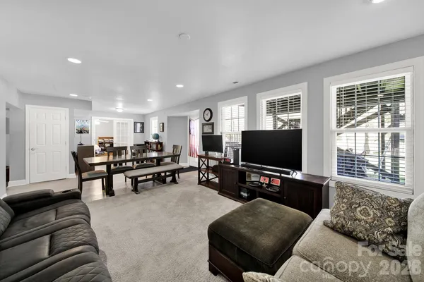a living room with furniture and a book shelf
