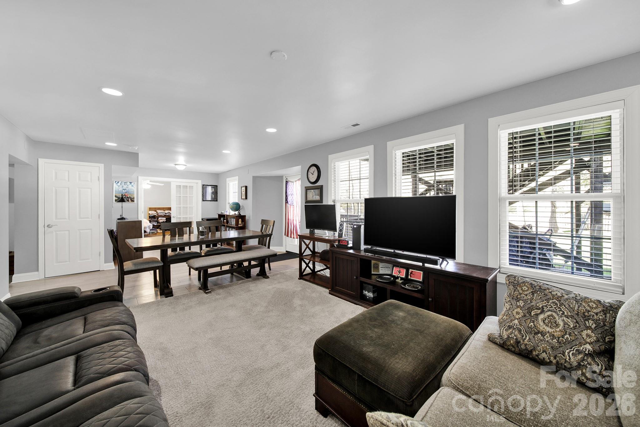 263 Fox Hollow Road Mooresville, NC 28117 - Photo 33 of 44 a living room with furniture and a flat screen tv