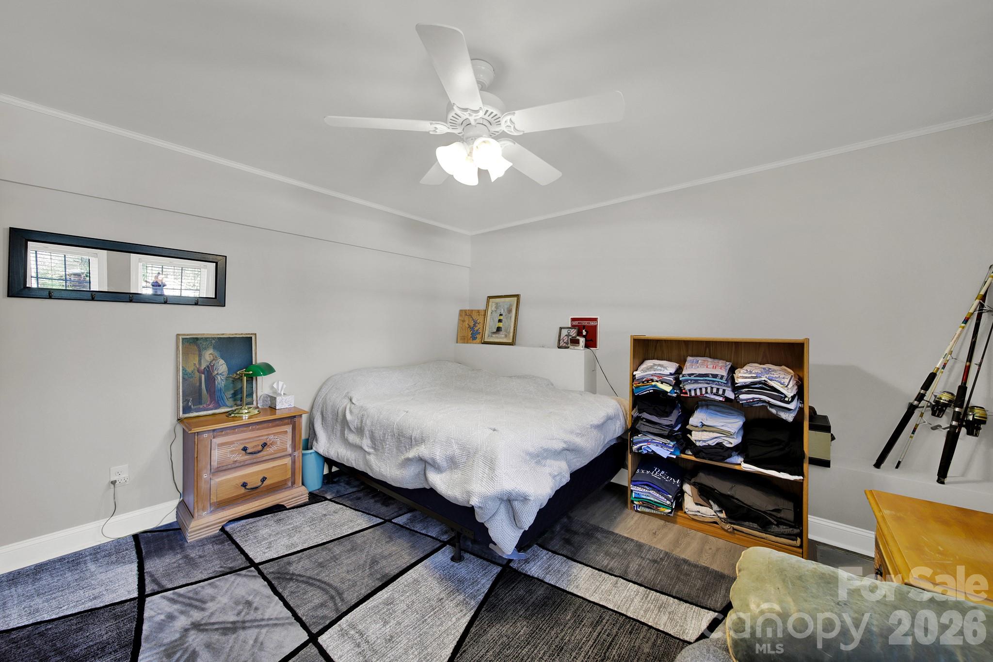 263 Fox Hollow Road Mooresville, NC 28117 - Photo 35 of 44 a bedroom with a bed and a chandelier