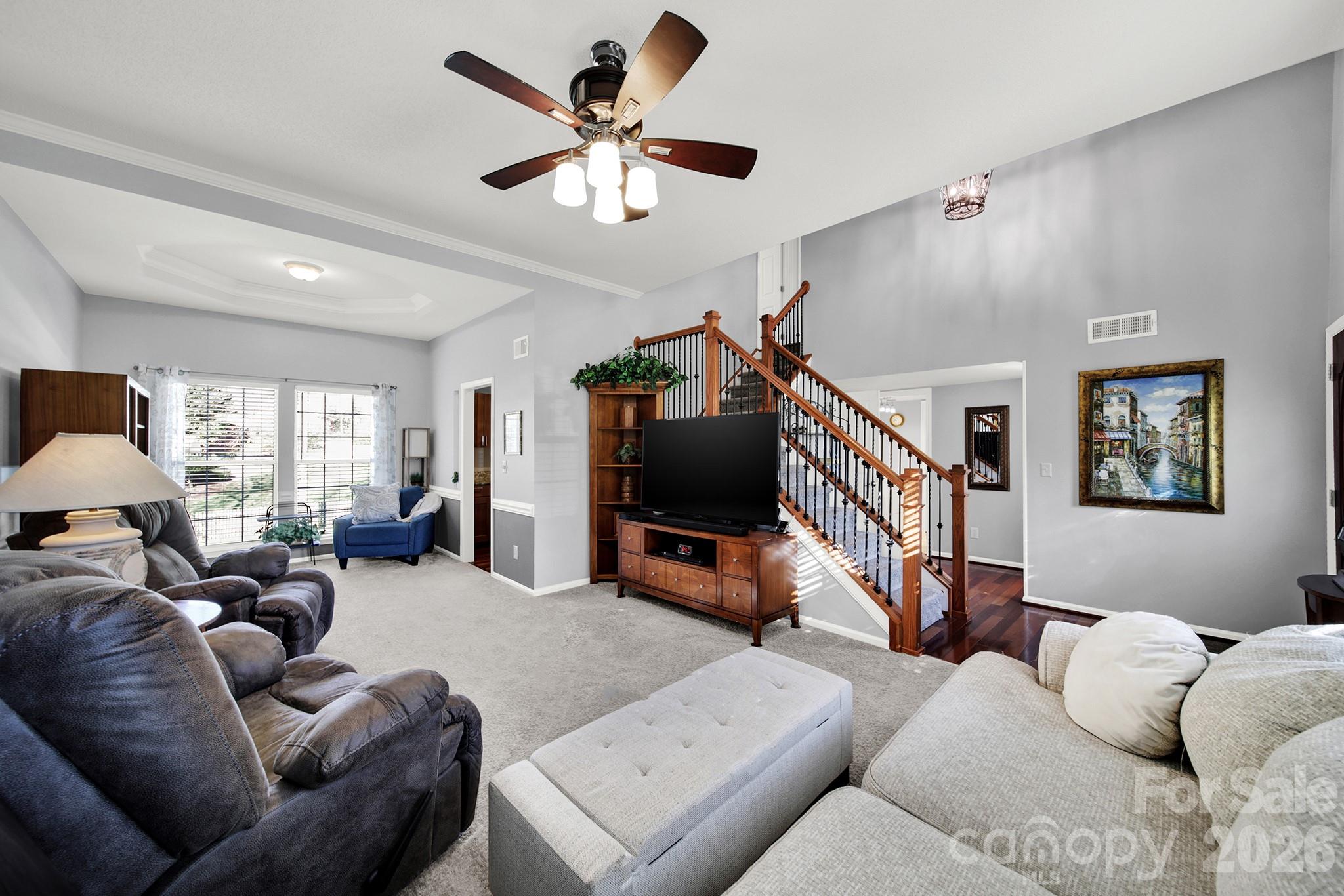 263 Fox Hollow Road Mooresville, NC 28117 - Photo 5 of 44 a living room with furniture and a flat screen tv