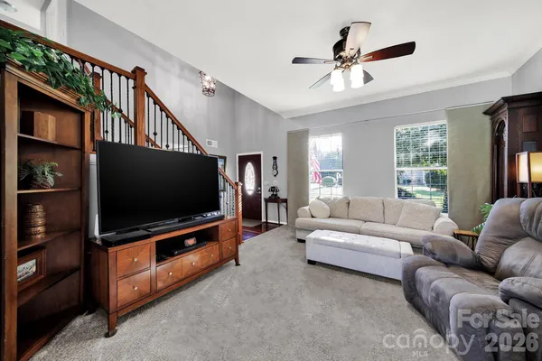 a living room with furniture and a flat screen tv