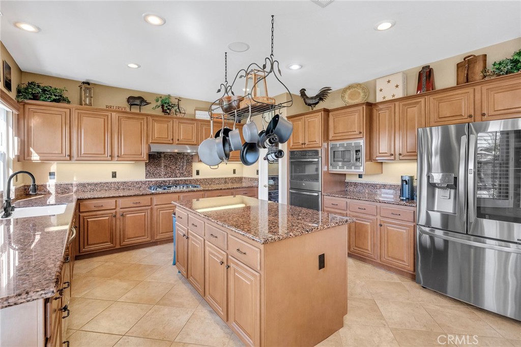 14143 Ashton Lane Riverside, CA 92508 - Photo 13 of 40 a kitchen with stainless steel appliances granite countertop a sink counter space cabinets and a large window