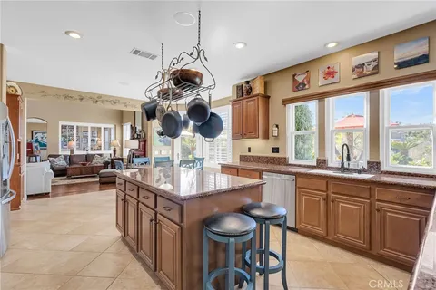 a kitchen with a sink a counter space appliances and a window
