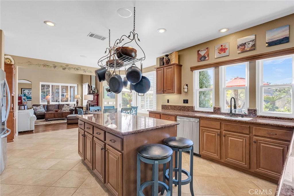 14143 Ashton Lane Riverside, CA 92508 - Photo 15 of 40 a kitchen with a sink a counter space appliances and a window