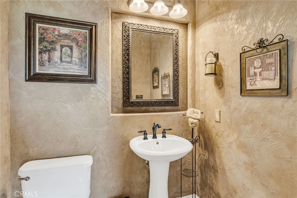 14143 Ashton Lane Riverside, CA 92508 - Photo 20 of 40 a bathroom with a toilet and a sink