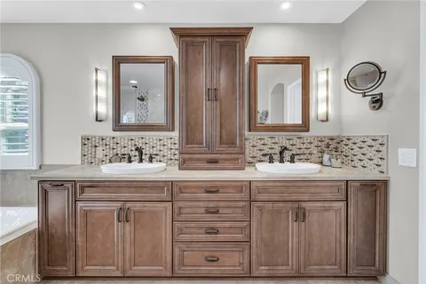 a spacious bathroom with a granite countertop tub sink shower and mirror
