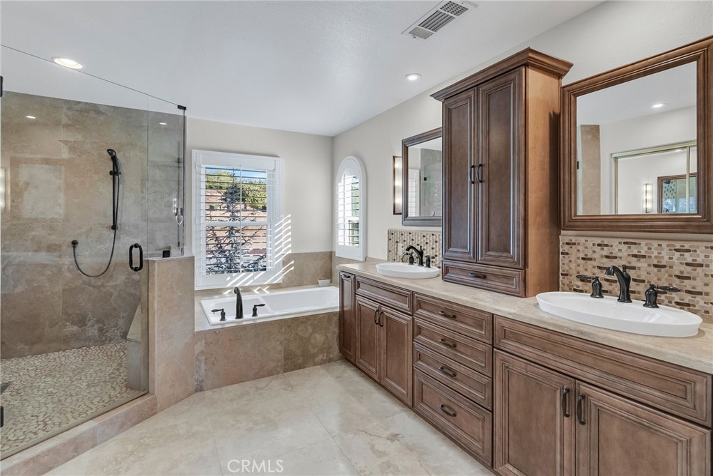 14143 Ashton Lane Riverside, CA 92508 - Photo 24 of 40 a spacious bathroom with a granite countertop tub sink shower and mirror