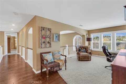 a livingroom with workspace couch and a window