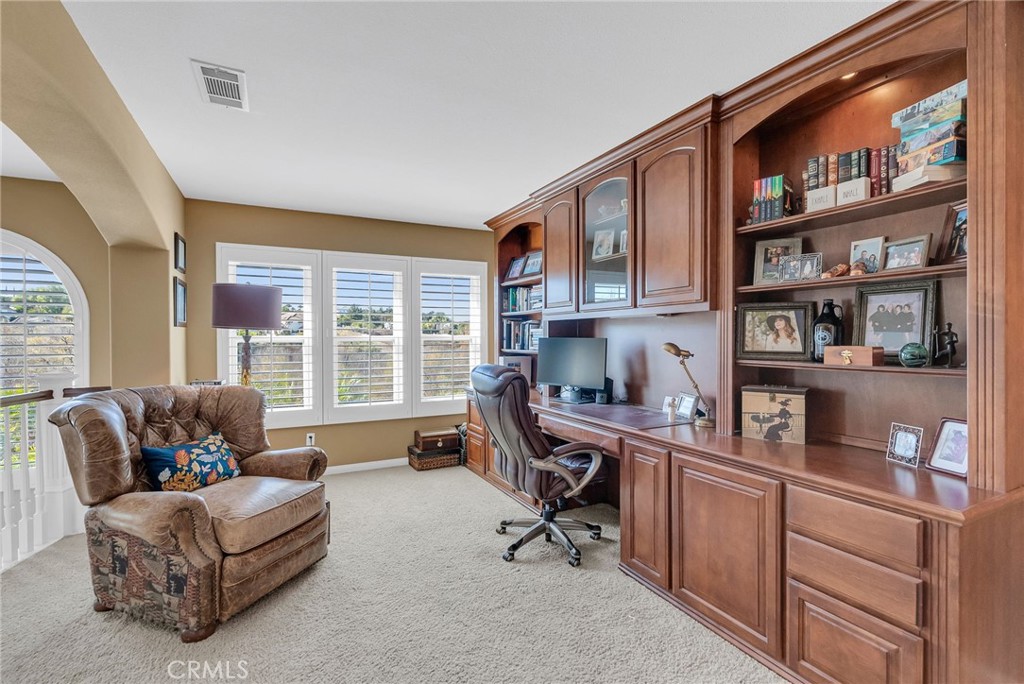 14143 Ashton Lane Riverside, CA 92508 - Photo 27 of 40 a livingroom with workspace couch and a window