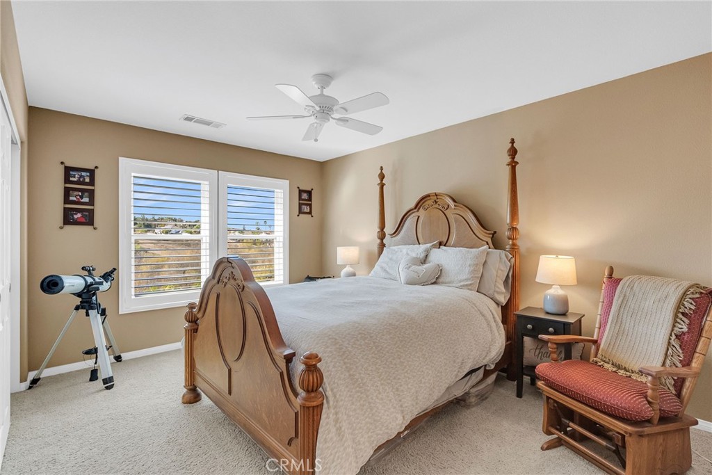 14143 Ashton Lane Riverside, CA 92508 - Photo 31 of 40 a bedroom with a bed and a couch