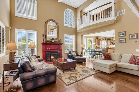 a living room with furniture fireplace and a window