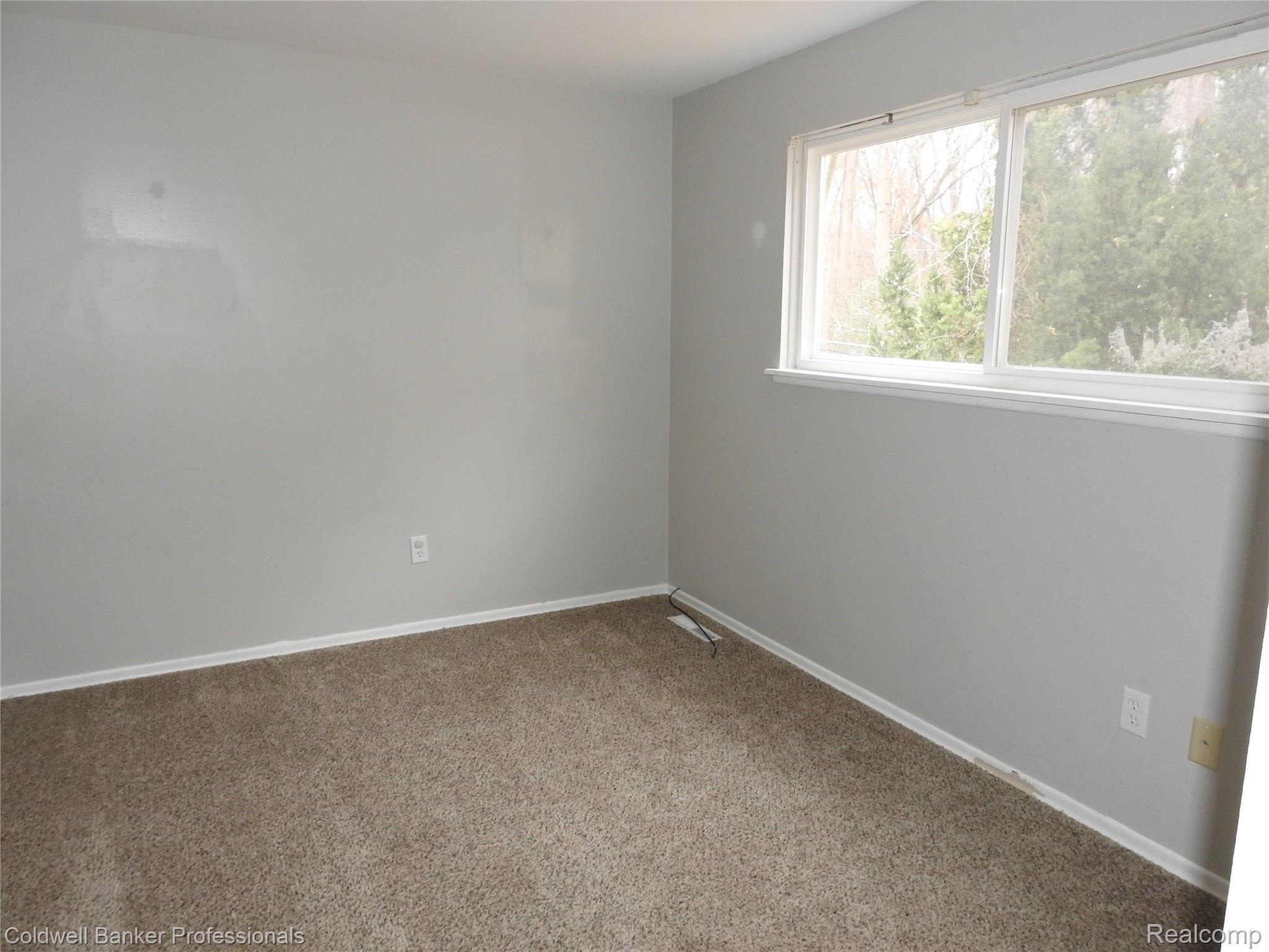 5919 Western Road Flint, MI 48506 - Photo 16 of 26 Carpeted spare room featuring baseboards