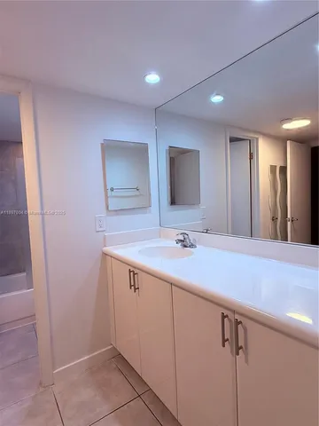 a bathroom with a sink a vanity and a mirror