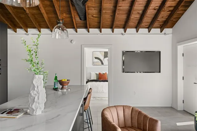 a view of a room with wooden floor and a window