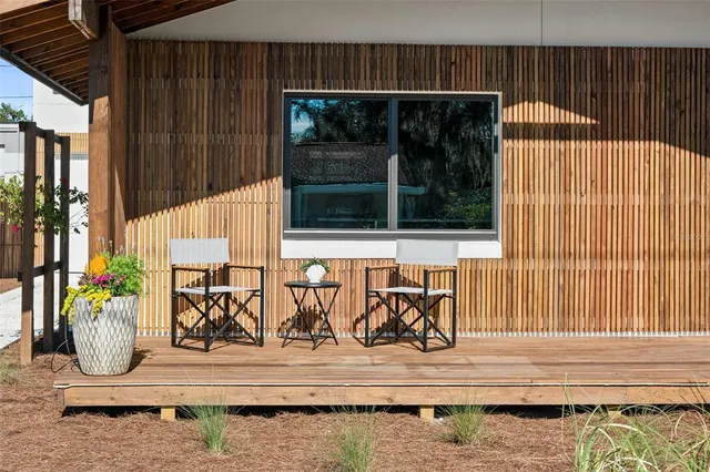 a view of wooden door with a bench