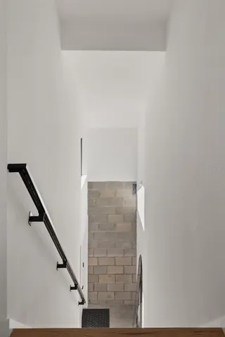 a kitchen with stainless steel appliances a sink cabinets and a window