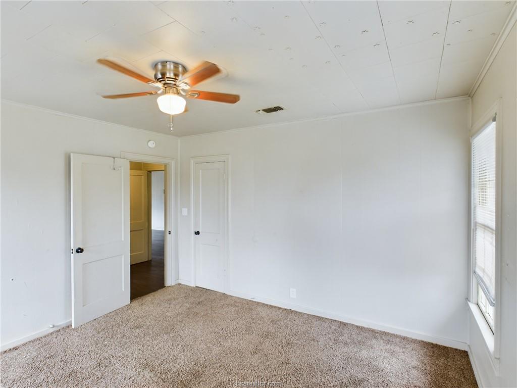 1316 Antone Street, Unit B Bryan, TX 77803 - Photo 5 of 7 Spare room with carpet floors, crown molding, and a ceiling fan