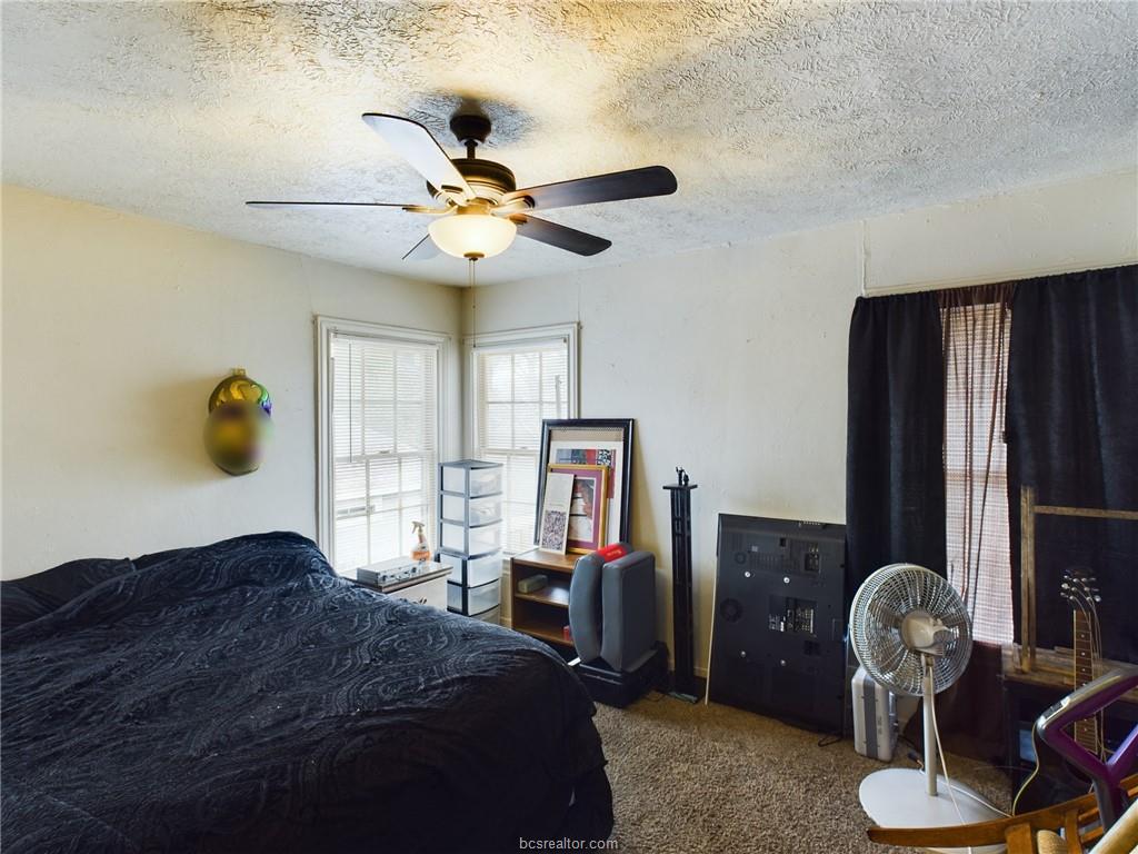 1316 Antone Street, Unit B Bryan, TX 77803 - Photo 7 of 7 Carpeted bedroom featuring a textured ceiling and a ceiling fan