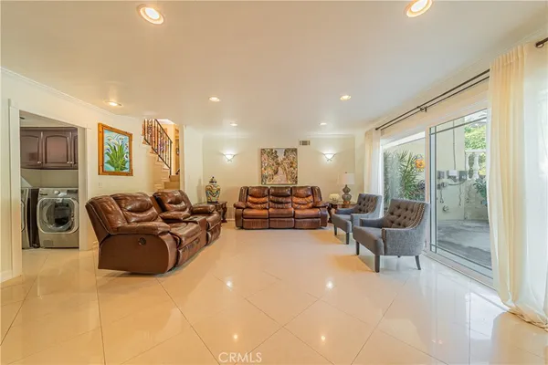 a living room with furniture large window and flat screen tv