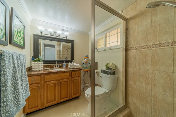 a en suite bathroom with a sink a mirror and a shower