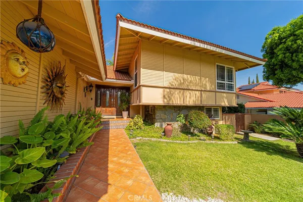 a front view of a house with garden