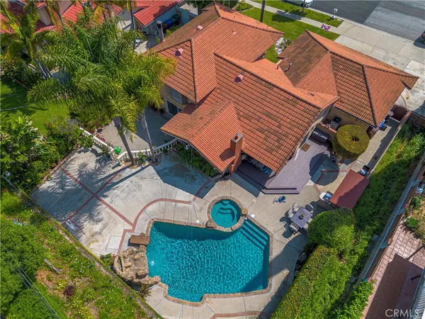 an aerial view of a house with a swimming pool and outdoor seating