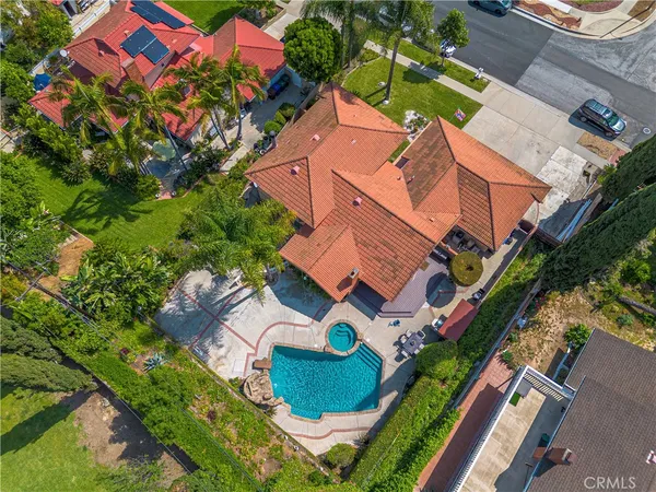 an aerial view of a house with a yard and outdoor seating